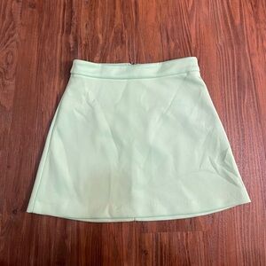 Mint green mini skirt with a gold zipper in the back. Size S